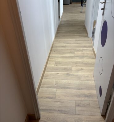 Pose d’un parquet stratifié dans un dégagement avec finition raboutée des plinthes